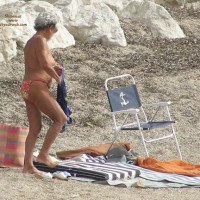 Old Woman Changing On The Beach